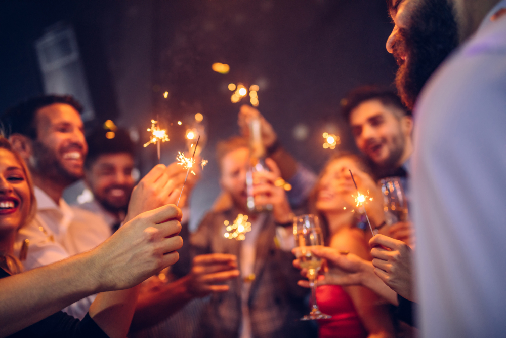 Group,Of,Young,People,Celebrating,With,Champagne,And,Sparklers